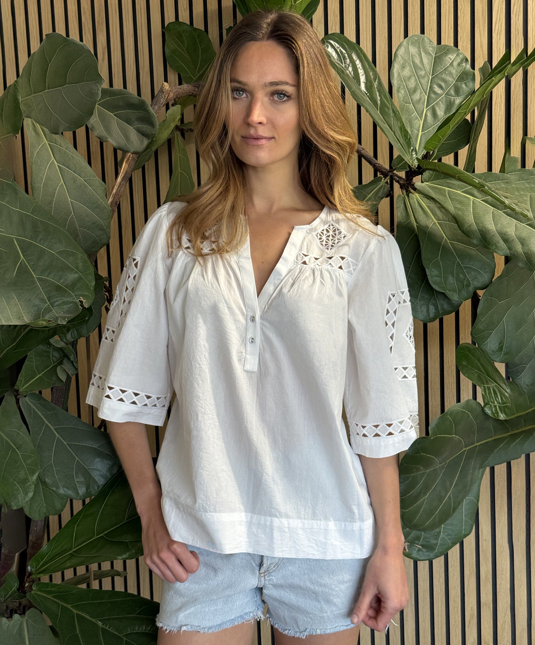 A model wearing a Rose and Rose Bordeaux top in white.