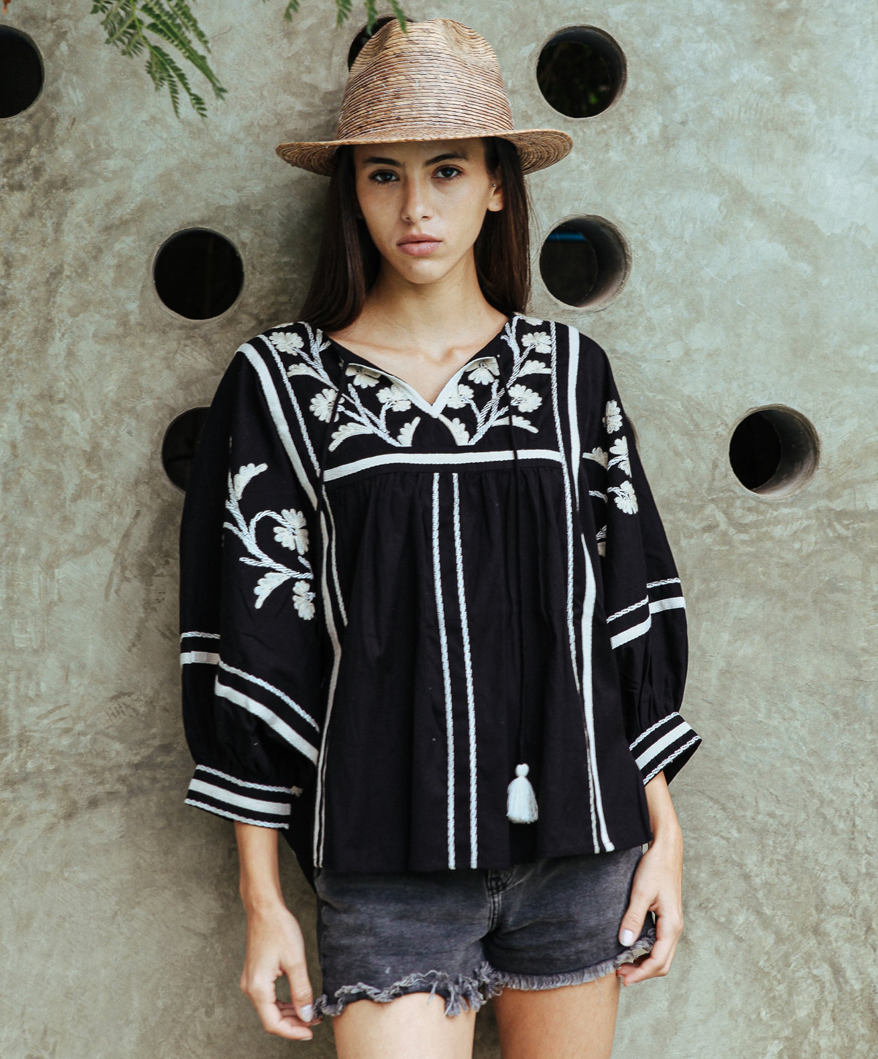 A model wearing a Rose and Rose Camden embroidered top in black cotton. 