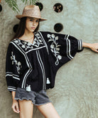 A model wearing a Rose and Rose Camden embroidered top in black cotton. 