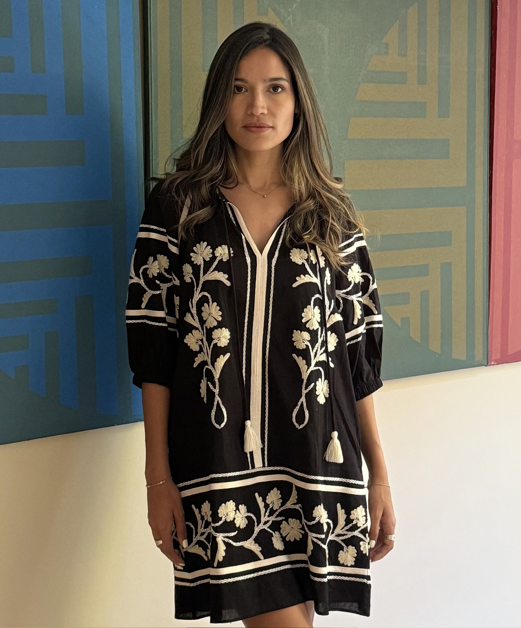 A model wearing a Rose and Rose Camden embroidered dress in black cotton.