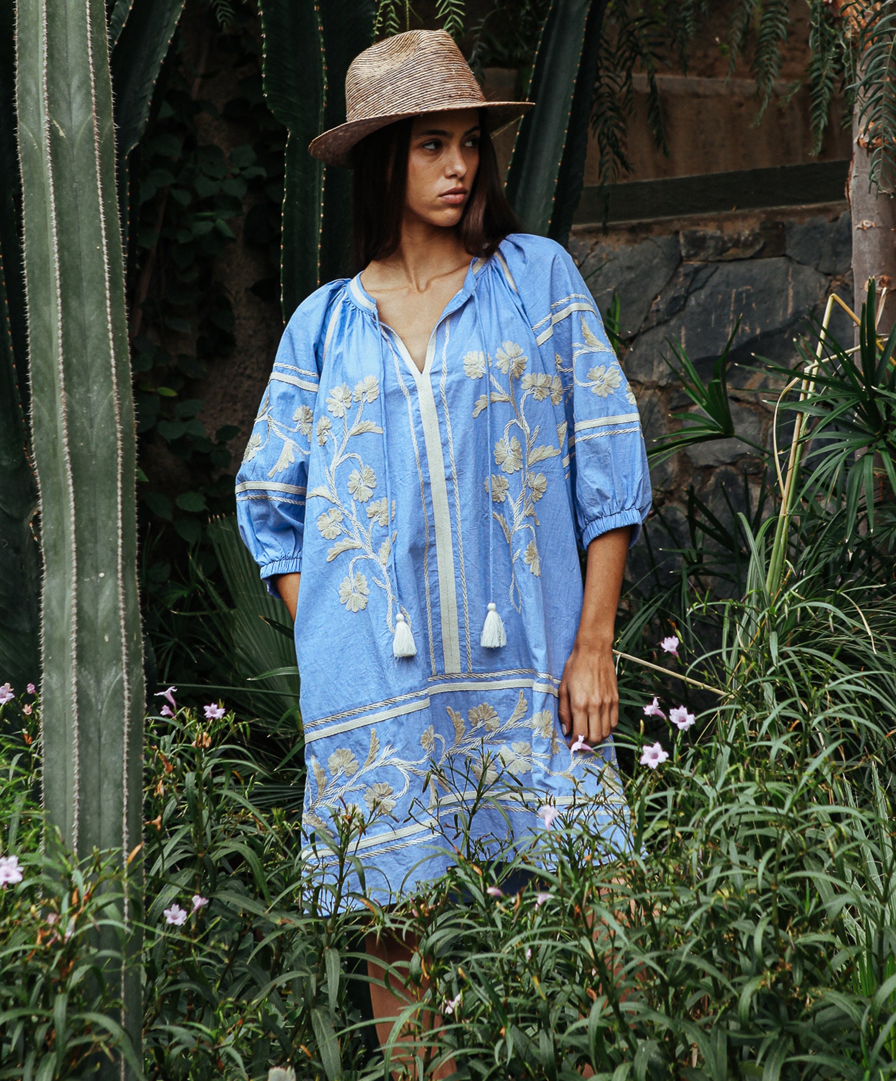 A model wearing a Rose and Rose Camden embroidered dress in blue cotton.