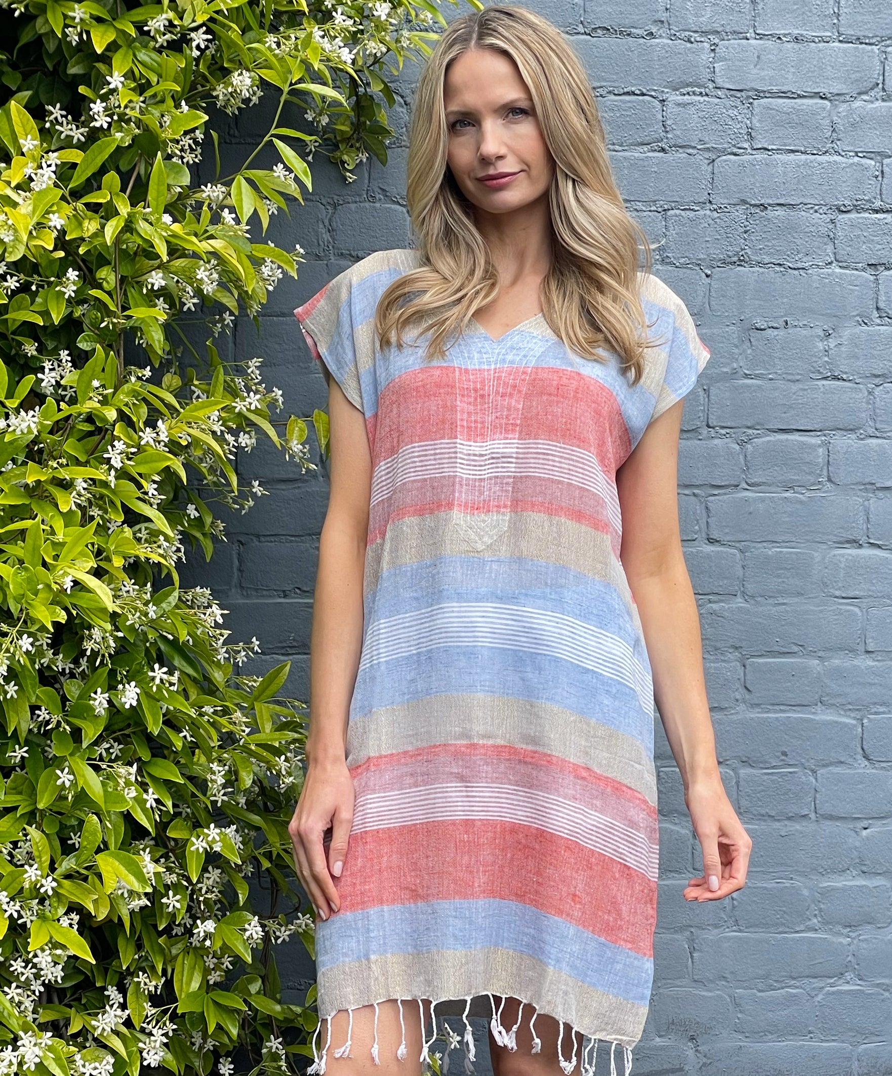 A model wearing a Rosebud by Rose and Rose red, blue and gold lurex striped kaftan.