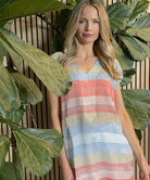 A model wearing a Rosebud by Rose and Rose red, blue and gold lurex striped kaftan.