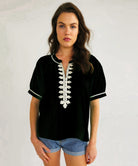A model wears a Rose and Rose Cote D'Azure top in black.