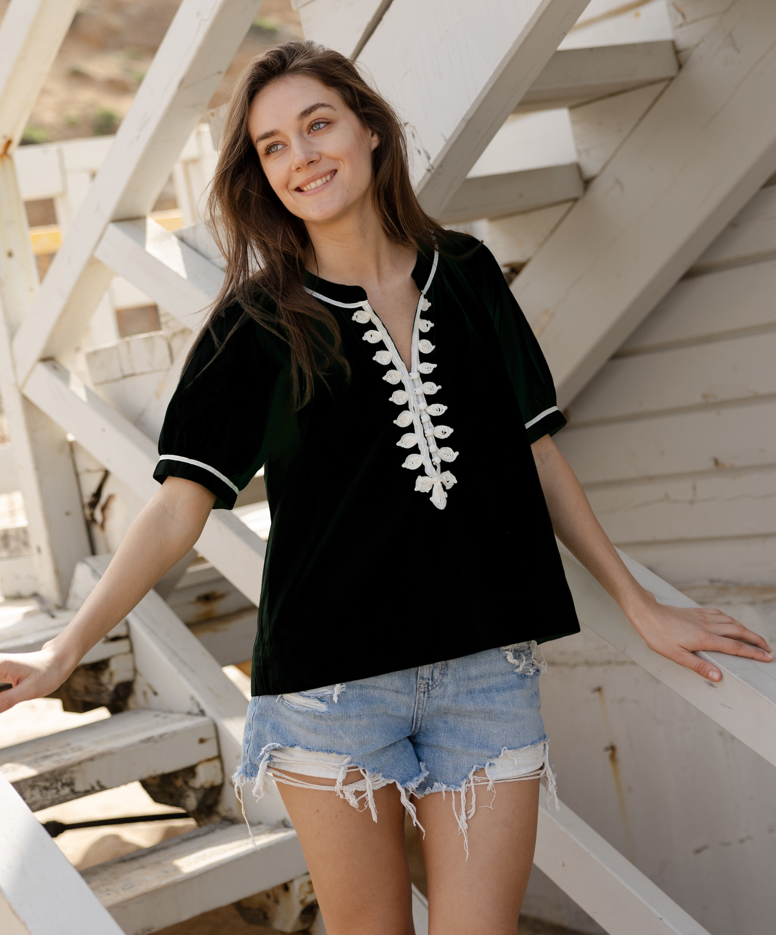 A model wears a Rose and Rose Cote D'Azure top in black.