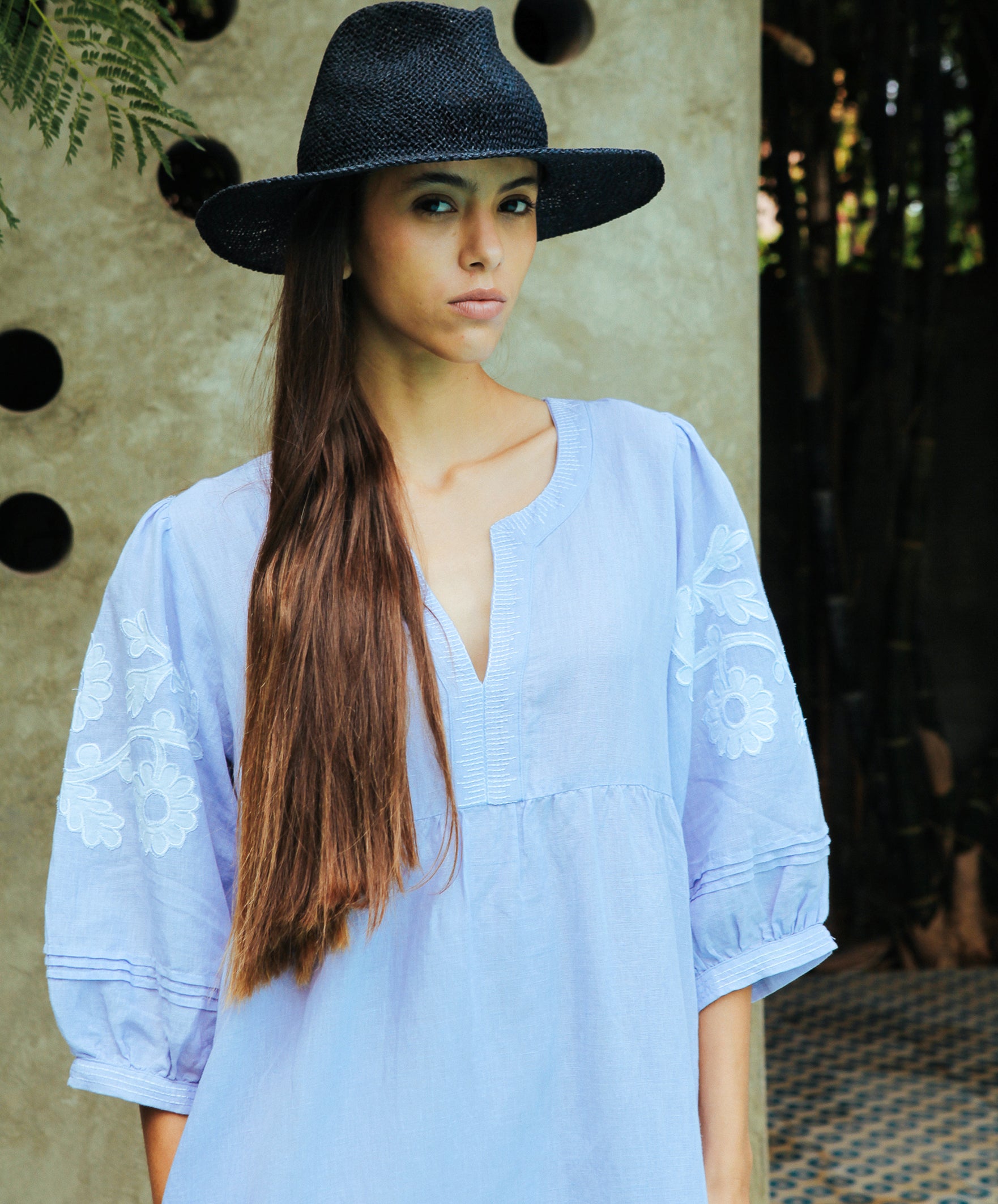 Close up details of the Rose and Rose Grange embroidered dress in blue linen.