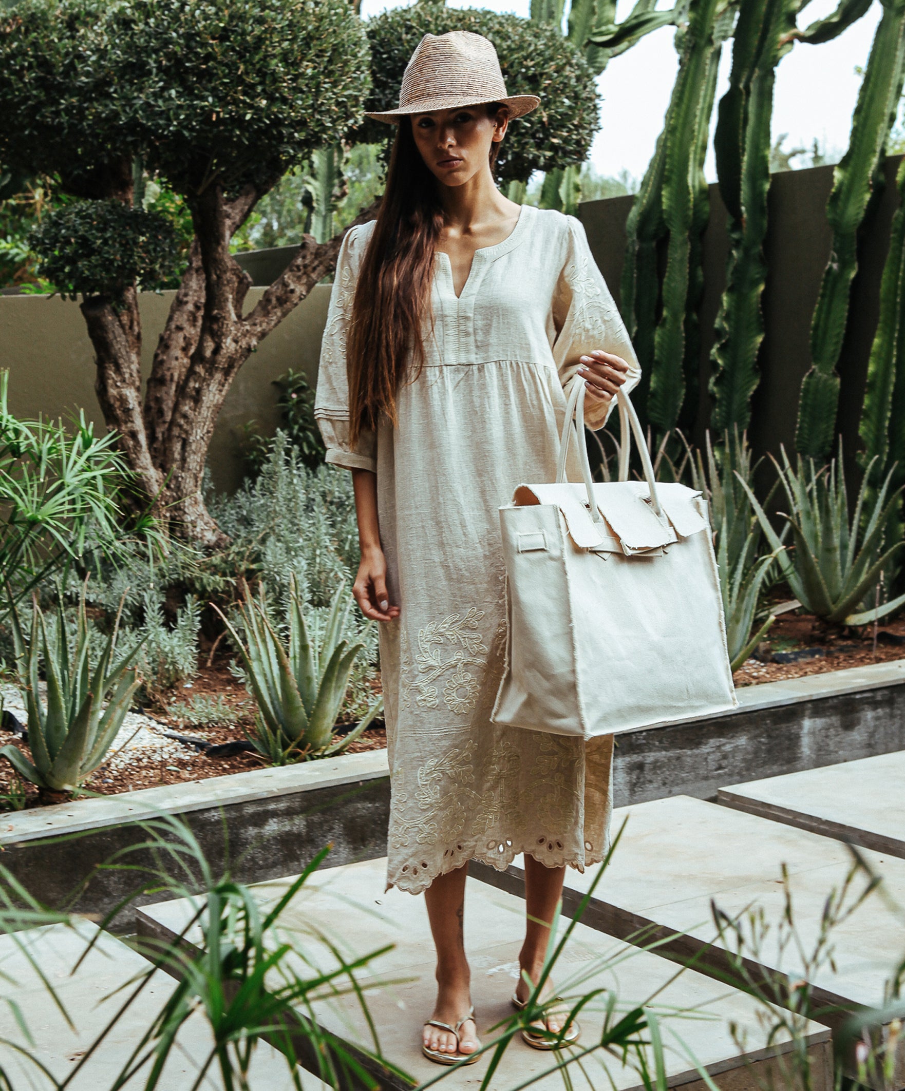 A model wearing a Rose and Rose Grange embroidered dress in natural linen.