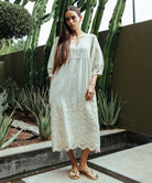 A model wearing a Rose and Rose Grange embroidered dress in natural linen.