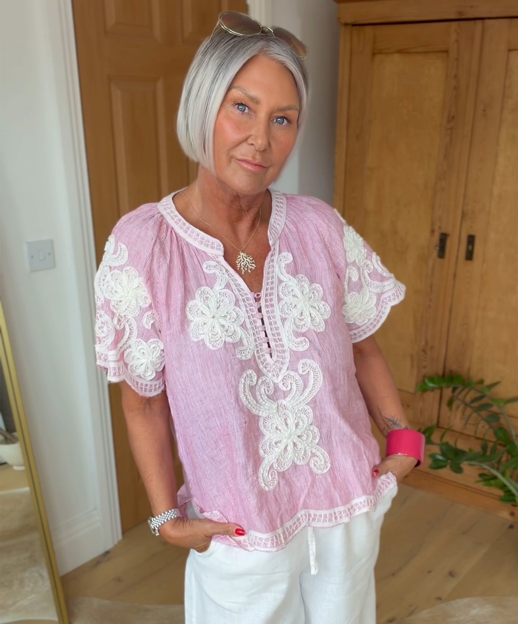 Influencer @simpsonhouse wearing the red striped Azalea top with white embroidery decoration.