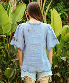 Back view of a model wearing a Rose and Rose embroidered Kew top. 