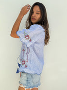 Side view of a model wearing a Rose and Rose embroidered Kew top. 