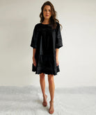 A model wears a Rose and Rose La Rochelle dress in black.