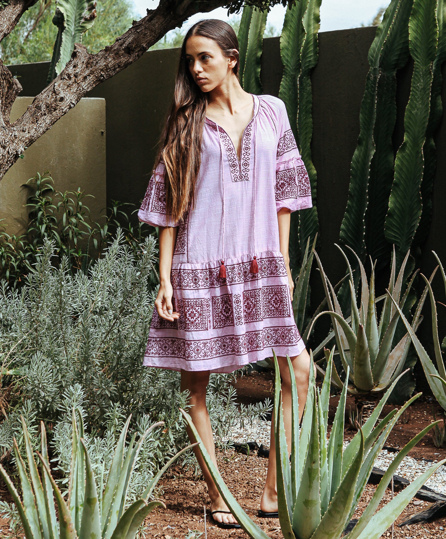 Model wearing a Rose and Rose embroidered Notting hill pink dress. 