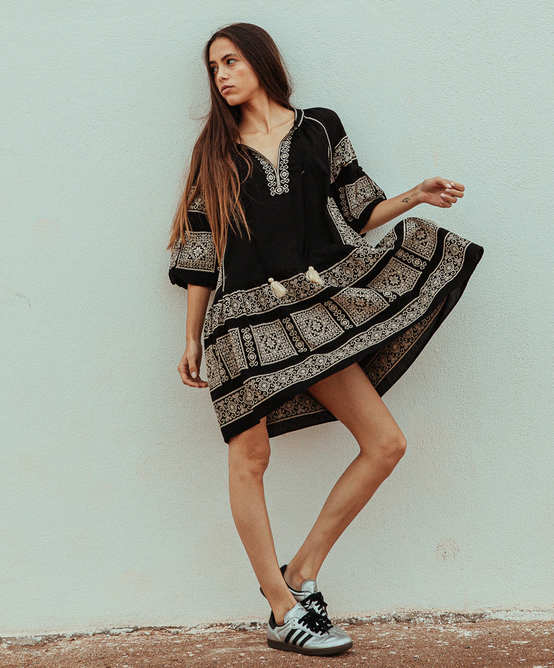 Model wearing a Rose and Rose embroidered Notting hill dress in black cotton.