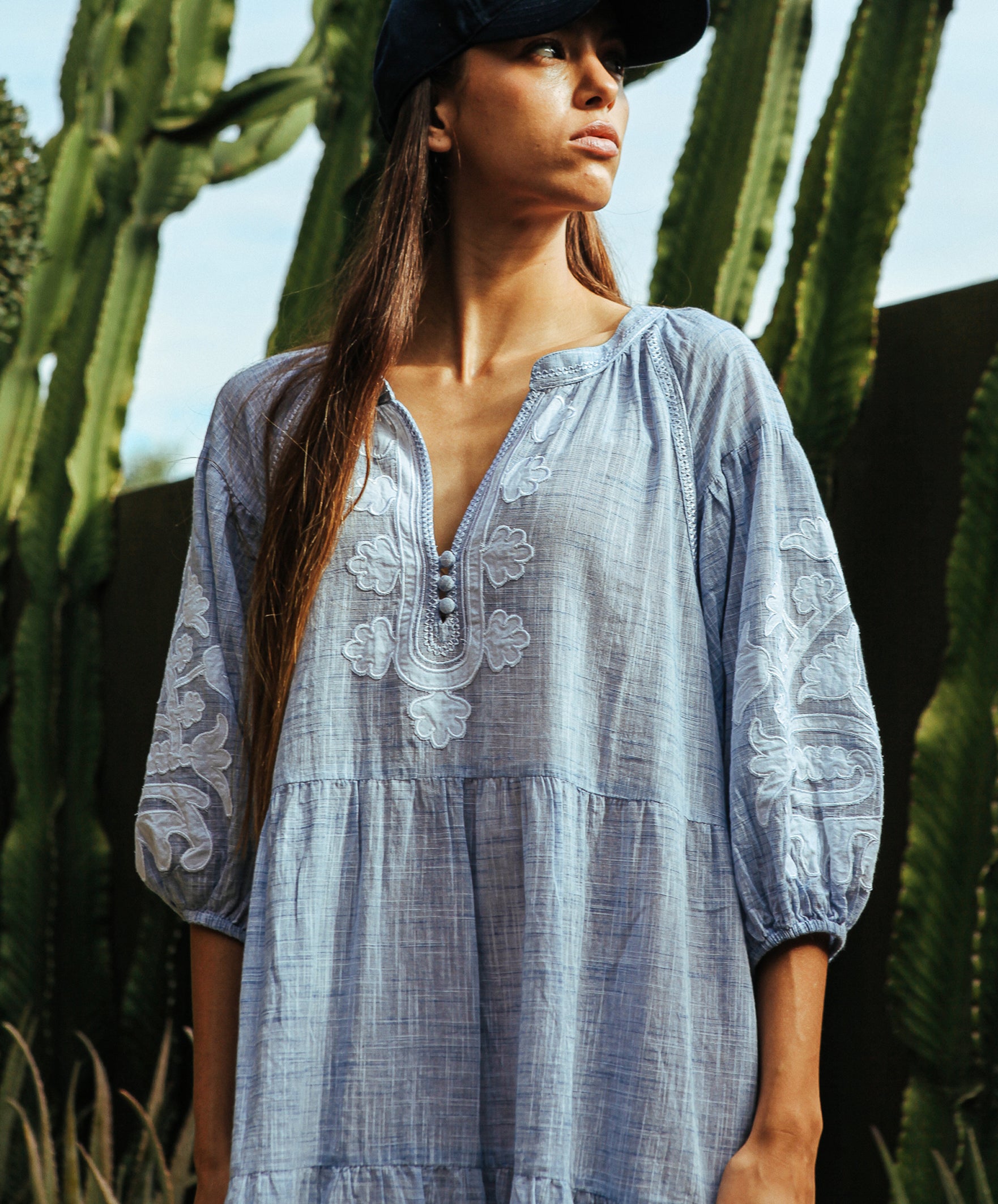 Details of the Rose and Rose Oxford dress in marl blue with white appliqué decoration.