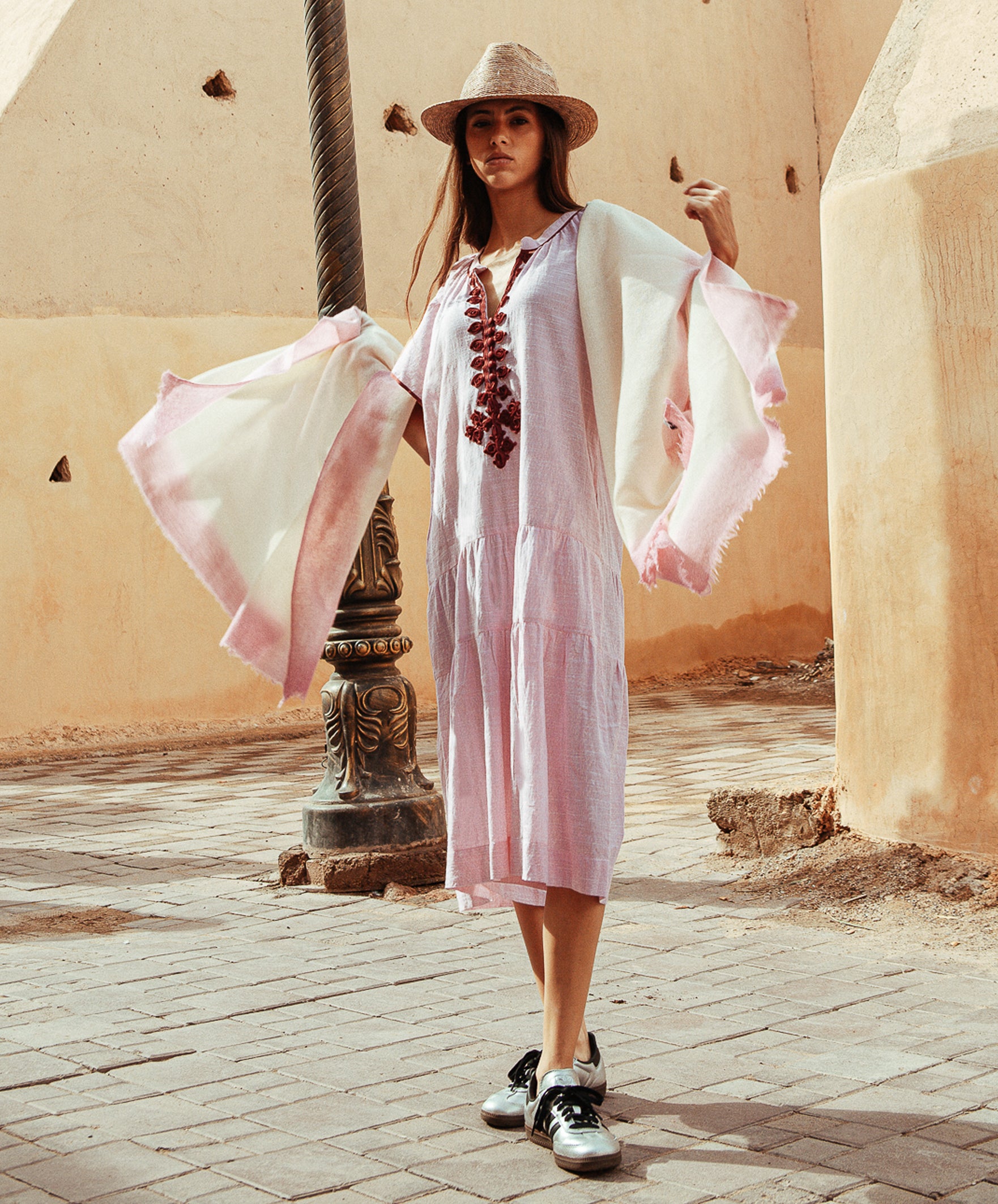 A model wearing a Rose and Rose Uxbridge dress and a cashmere wrap draped around her shoulders. 