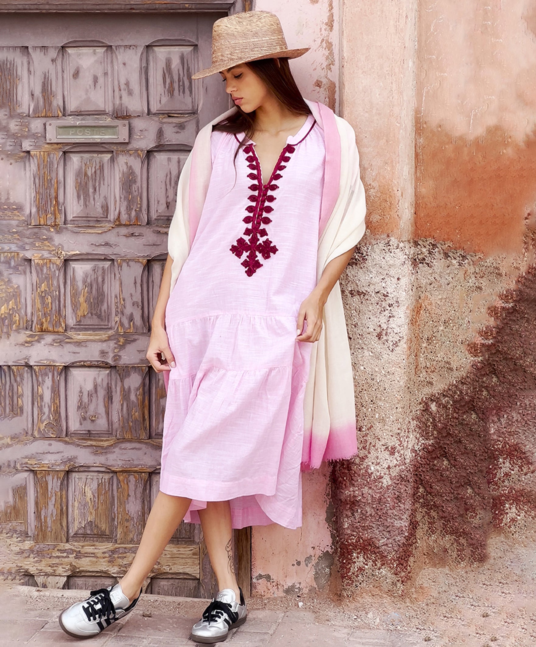 A model wearing a Rose and Rose Uxbridge dress and a cashmere wrap draped around her shoulders. 