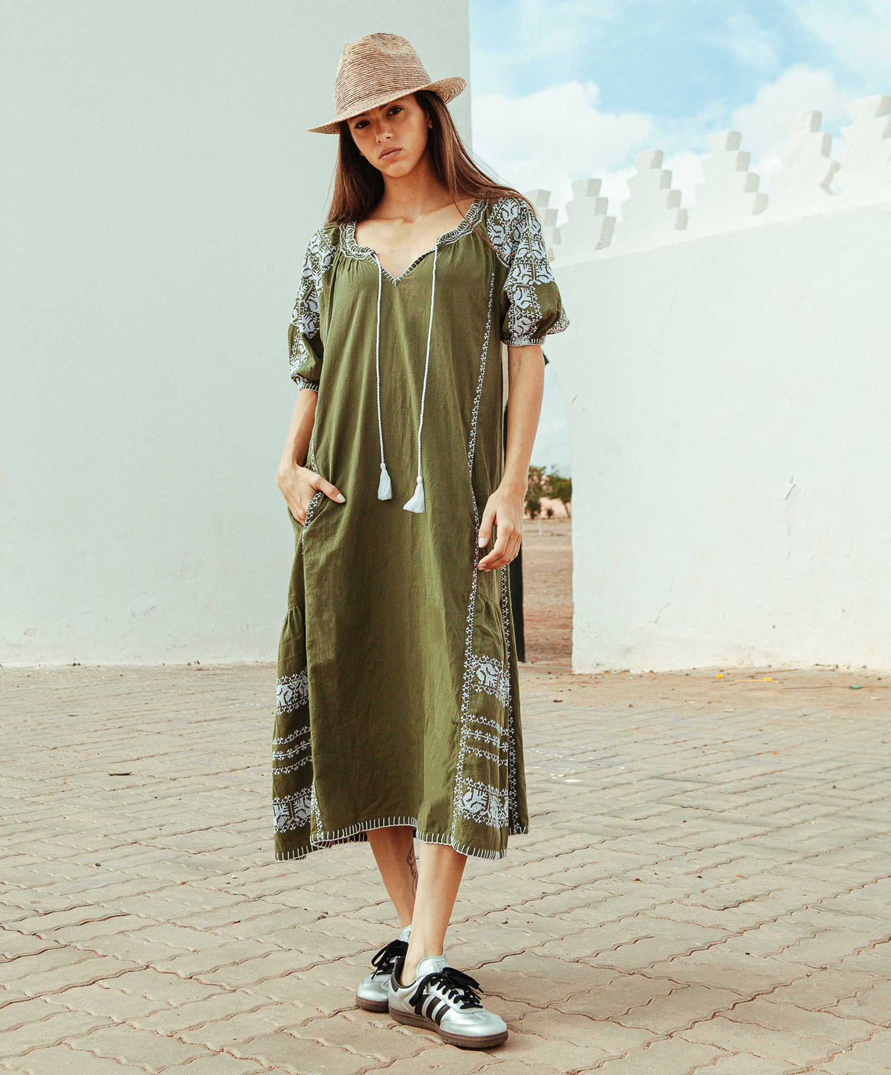 Model wears a Rose and Rose embroidered Royal Oak dress in olive cotton