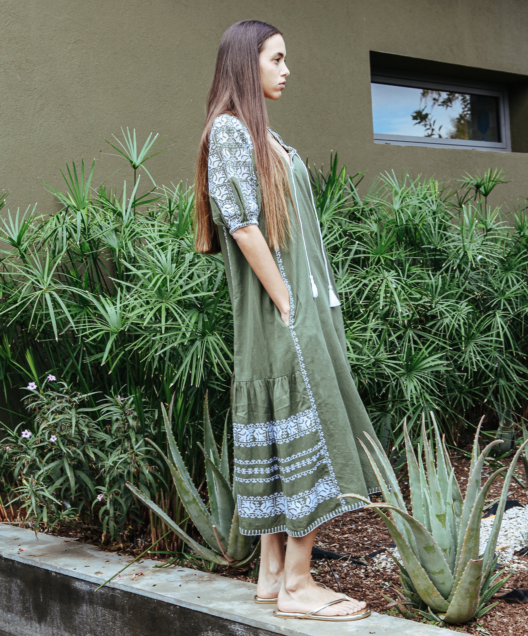 Size view of model wearing a Rose and Rose embroidered Royal Oak dress in olive cotton.