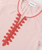 Pink garment with coral embroidery and 'Rose & Rose' label.
