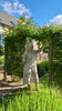 Influencer @shutters_and_stone wearing the Magnolia natural embroidered dress walking around her garden. 