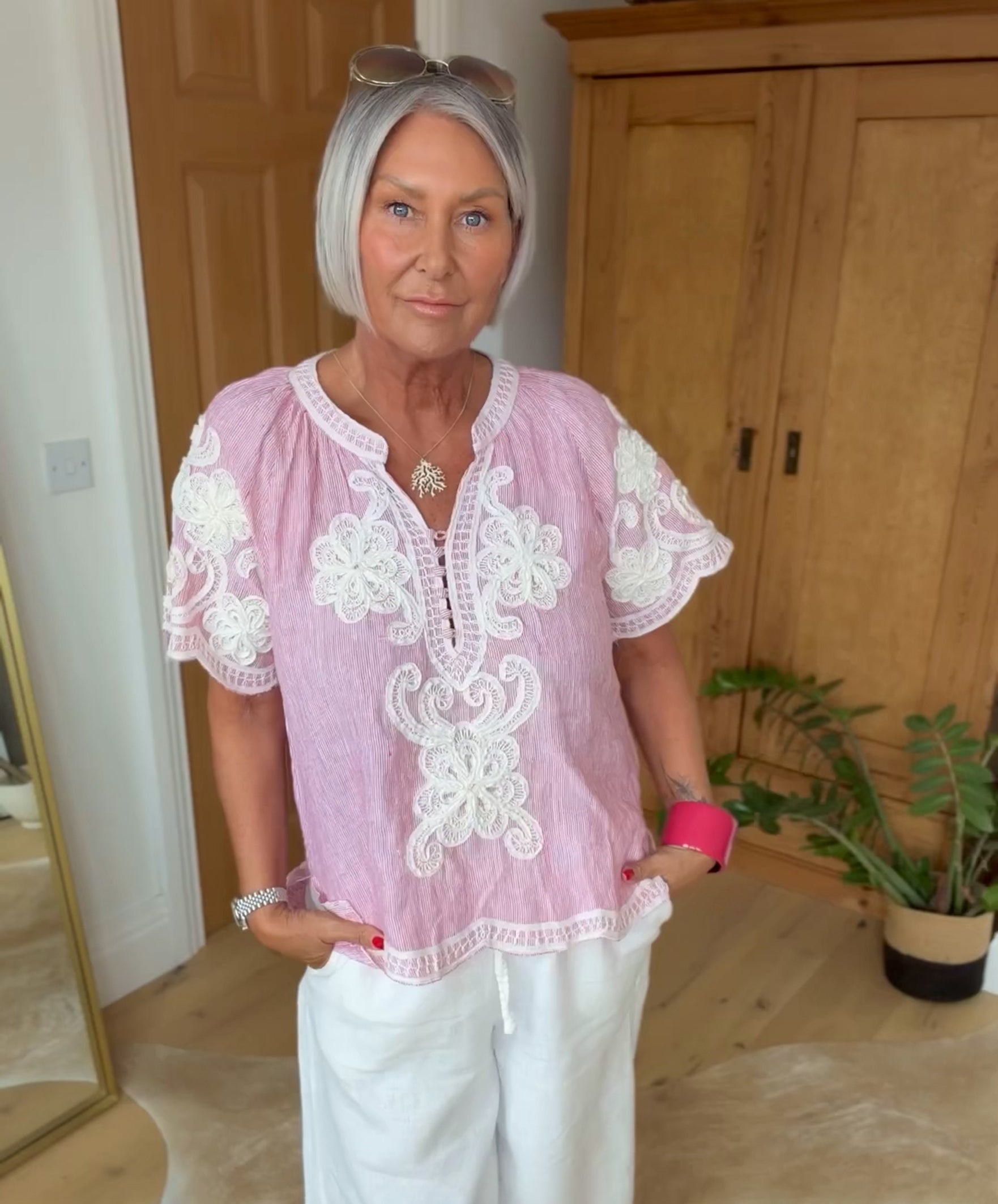 Influencer @simpsonhouse wearing the red striped Azalea top with white embroidery decoration.
